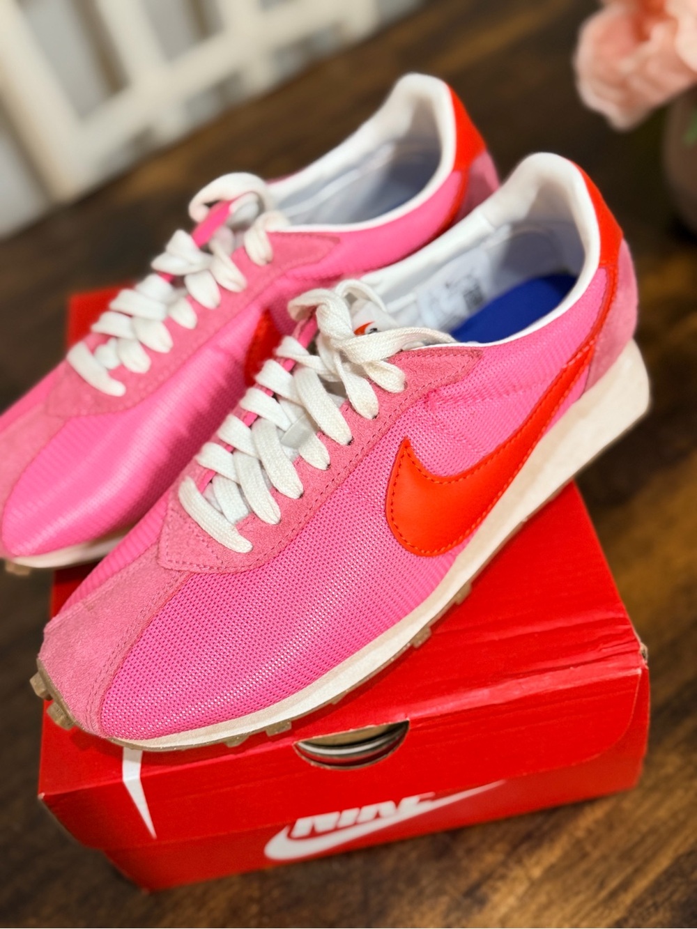 Nike Women's Pink Sneakers with Orange Swoosh